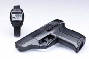 The Armatix smart gun is displayed with the RFID-enabled watch required to operate it.