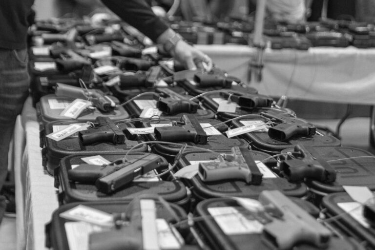 Pistols are displayed for sale on a table at a gun show in 2021.
