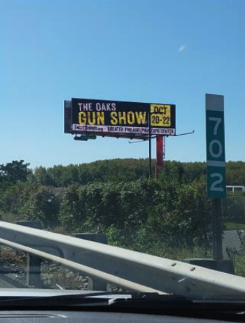 A billboard advertising the Oaks Gun Show placed along the New Jersey Turnpike.