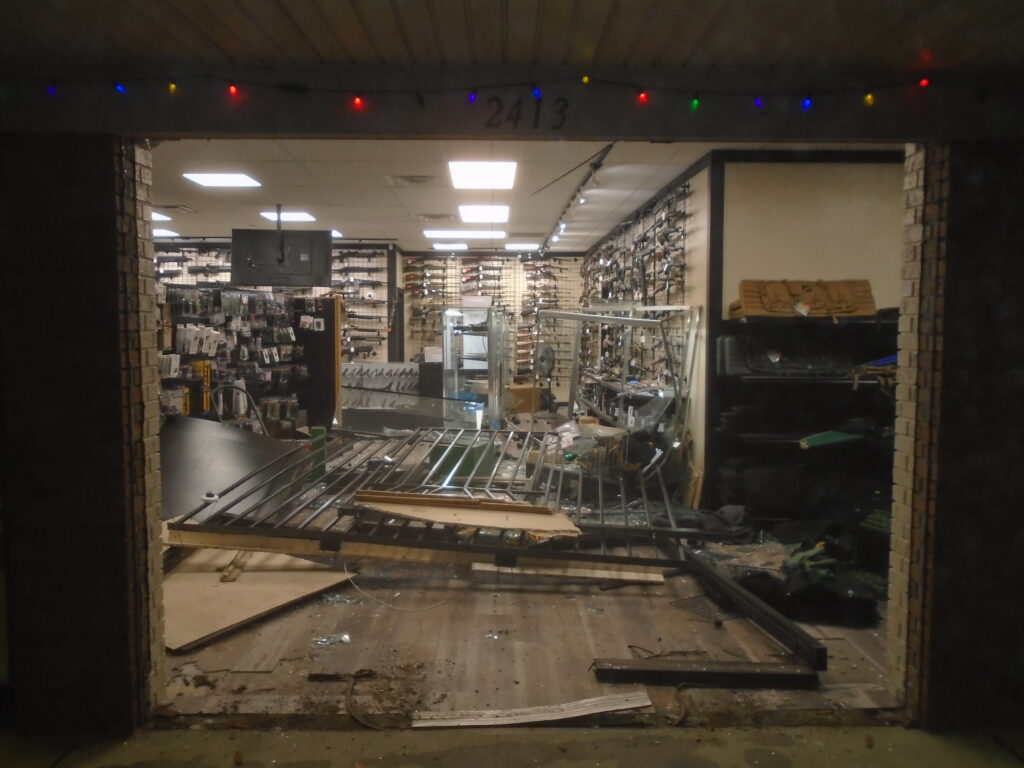 Photos from the Summit Armory gun store burglary show the smashed front entryway and the hammer used to break into glass display cases.