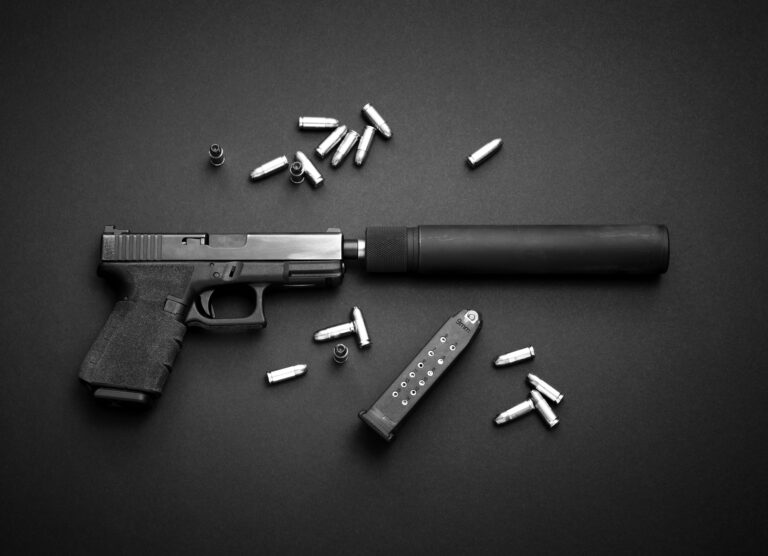 A semi-automatic Glock pistol equipped with a silencer is shown on a dark background with 9mm ammunition.