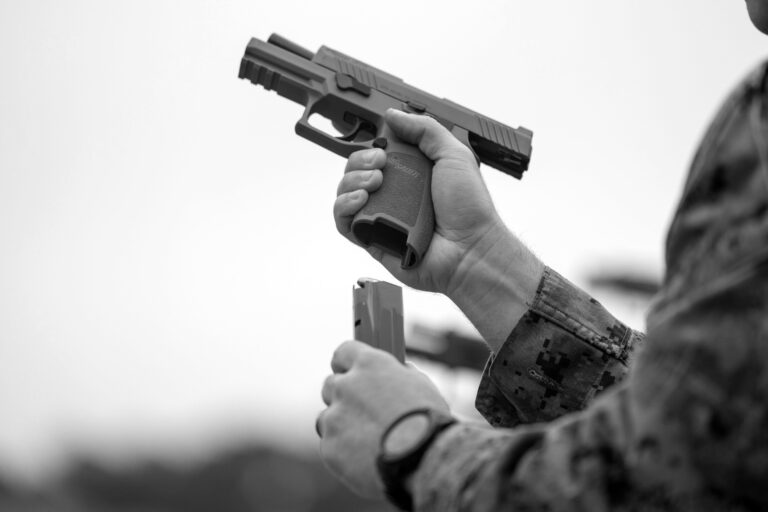 A Marine reloads an M18 pistol during a pistol qualification course. The Air Force Global Strike Command recently pulled the pistol from duty after an airman was killed by his holstered M18.