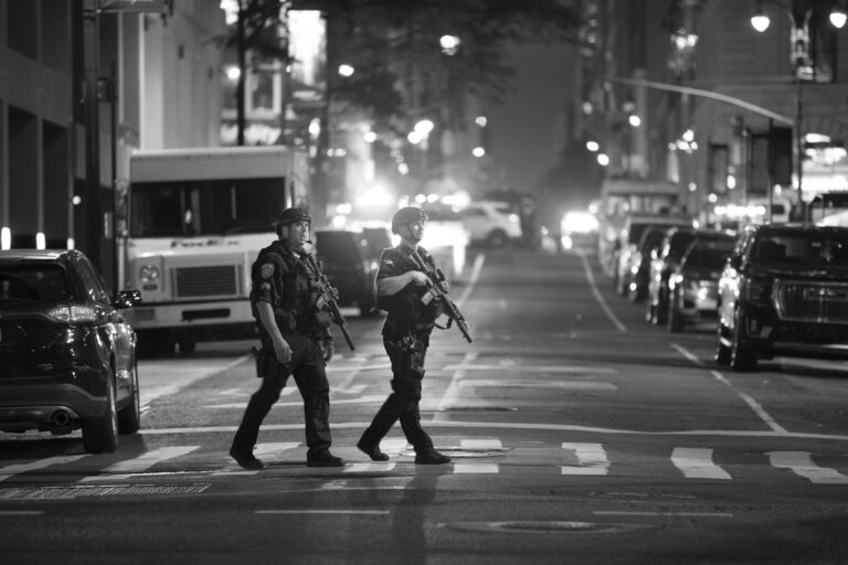 Police officers gather after responding to a mass shooting in Midtown Manhattan involving a gunman armed with a Palmetto State Armory AR-15.