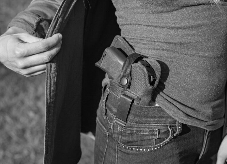 A woman displays the Ruger LC9s pistols she uses for concealed carry.
