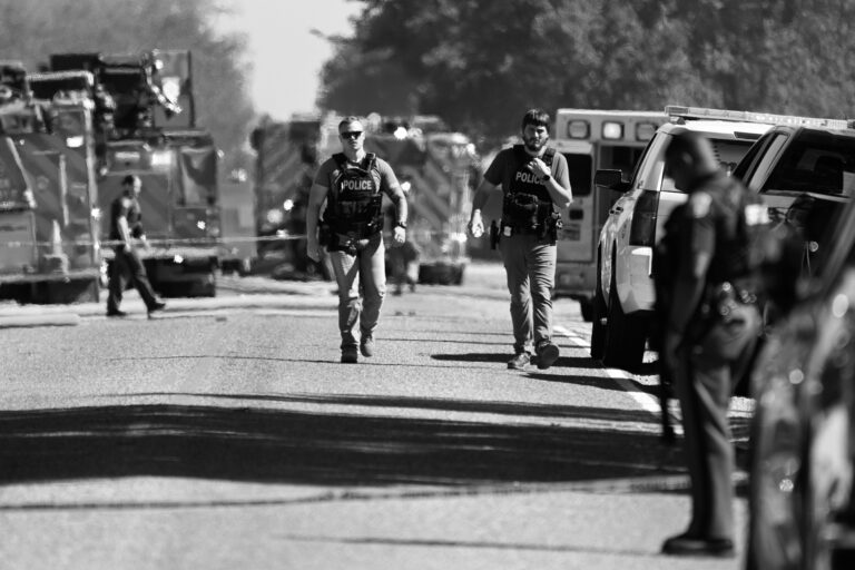 Police walk near the mass shooting that took place at The Church of Jesus Christ of Latter-day Saints on Sunday, September 28, 2025, in Grand Blanc, Michigan.