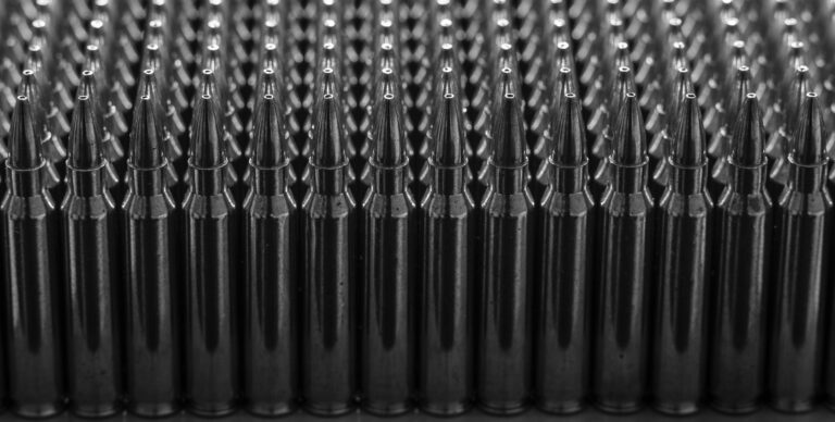 Rows of .223 Remington rifle rounds are shown on a table. CSG, a Czech conglomerate that owns the largest U.S. ammunition manufacturers, is considering going public.