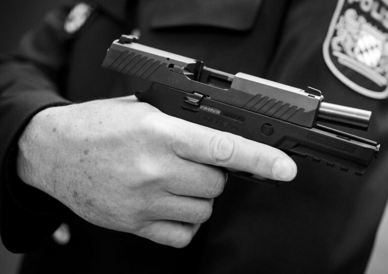 A police officer holds a Sig Sauer P320, which is now the subject of numerous lawsuits.