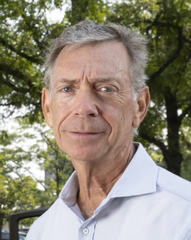 Daniel Perlman, the co-founder of the Highland Park Peace Project, or HP3, sits on a park bench.