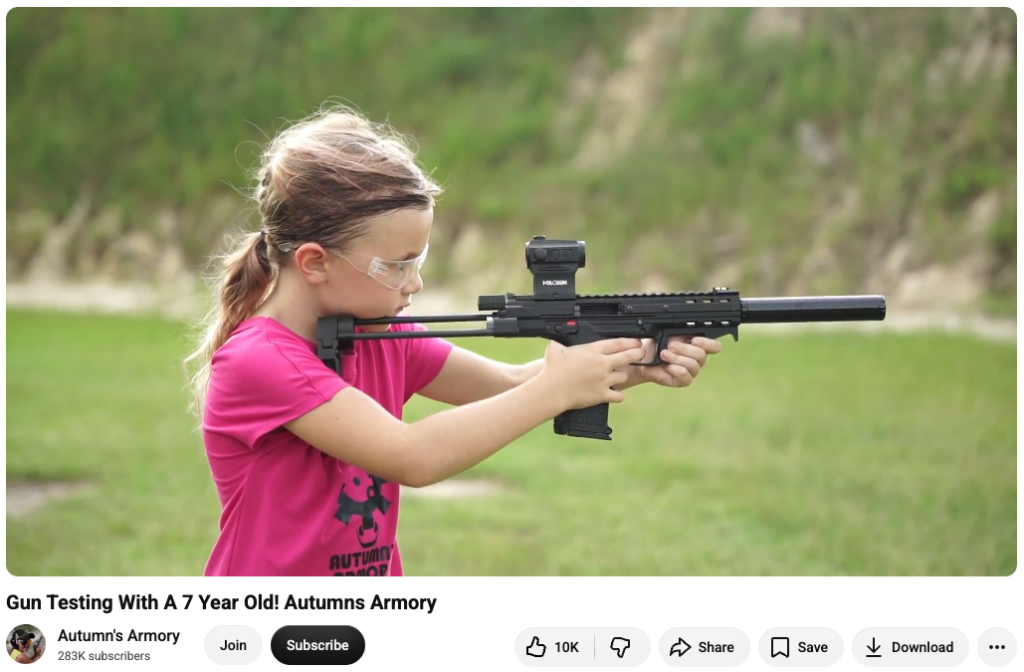 A screenshot of an Autumn's Armory video showing her firing a KelTec rifle with a silencer.